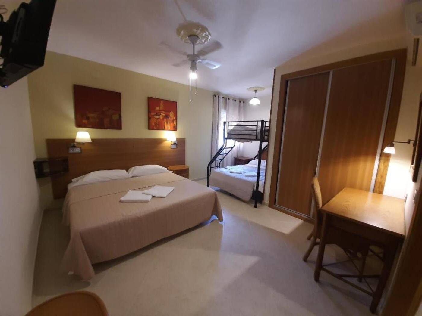 Family room with wardrobe and desk at Sotel Valle Guadiaro